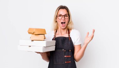 Sarışın, güzel bir kadın kendini mutlu hissediyor ve inanılmaz bir şeye hayret ediyor. Fast food konseptini kaldır.