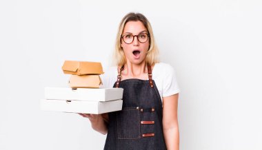 Sarışın, güzel bir kadın çok şaşırmış ya da şaşırmış görünüyor. Fast food konseptini kaldır.