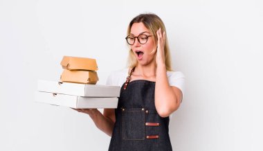 Sarışın, güzel bir kadın mutlu, heyecanlı ve şaşırmış hissediyor. Fast food konseptini kaldır.