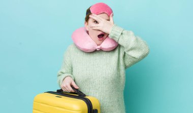 Kızıl saçlı güzel bir kadın şok olmuş, korkmuş ya da korkmuş görünüyor. uçuş yolcu kavramı