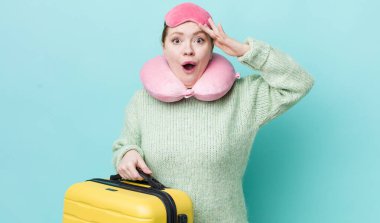 Kızıl saçlı güzel kadın mutlu, şaşkın ve şaşırmış görünüyor. uçuş yolcu kavramı