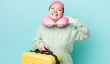 Kızıl saçlı, güzel bir kadın kendi gülüşünü işaret ediyor. uçuş yolcu kavramı