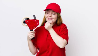 Kızıl saçlı, güzel bir kadın mutlu, kendinden emin, elleri çenesinde gülümsüyor. Packer çalışanı konsepti