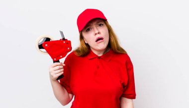 Kızıl saçlı güzel kadın şaşkın ve şaşkın hissediyor. Packer çalışanı konsepti