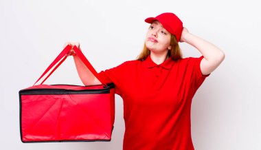 Kızıl saçlı güzel kadın mutlu bir şekilde gülümsüyor ve hayal kuruyor ya da şüphe ediyor. Pizza teslimatı kavramı