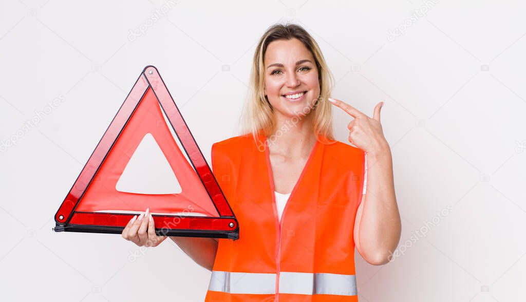 blonde pretty woman smiling confidently pointing to own broad smile. car triangle accident concept
