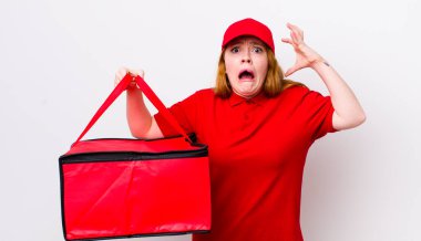 Kızıl saçlı güzel kadın ellerini havaya kaldırarak çığlık atıyor. Pizza teslimatı kavramı