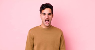 Yakışıklı İspanyol adam korkmuş ve şok olmuş hissediyor, ağzı açık şaşkınlık içinde.