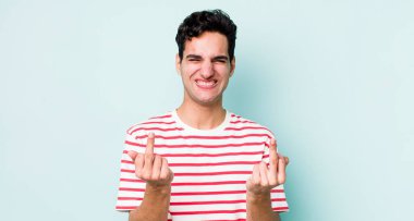 Yakışıklı İspanyol adam kışkırtıcı, agresif ve müstehcen hissediyor. İsyankar bir tavırla orta parmağını hareket ettiriyor.