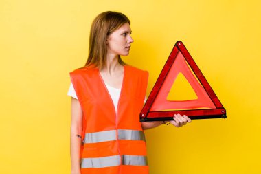 Profil bakışlı kızıl saçlı güzel kadın hayal mi kuruyor yoksa hayal mi kuruyor? Araba üçgeni tehlikesi