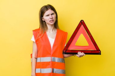 Kızıl saçlı güzel kadın şaşkın ve şaşkın hissediyor. Araba üçgeni tehlikesi