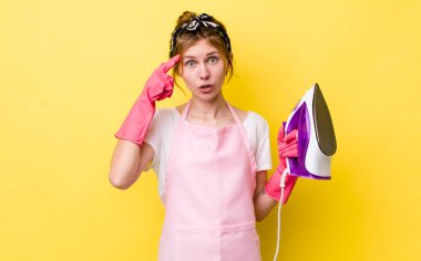 red head pretty woman looking surprised, realizing a new thought, idea or concept. housekeeper concept