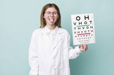 Kızıl saçlı, güzel, neşeli ve asi tavırlı, şaka yapan ve dilini dışarı çıkaran bir kadın. optik görüş testi konsepti