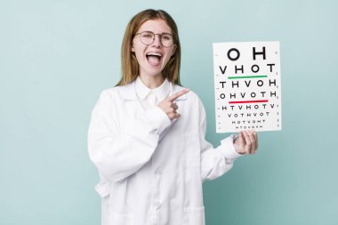 Kızıl saçlı, güzel bir kadın heyecanlı ve şaşırmış görünüyor. optik görüş testi konsepti