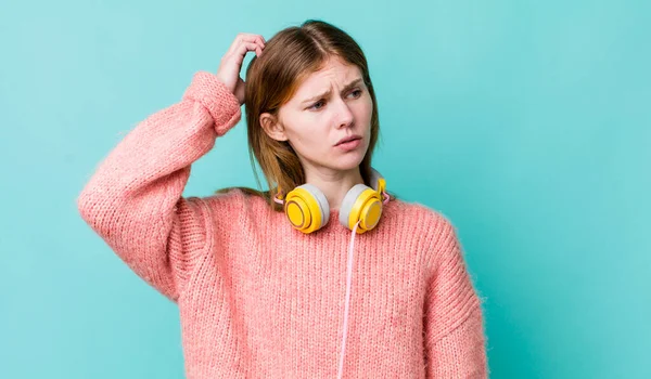 Red Head Pretty Woman Feeling Puzzled Confused Scratching Head Headphones — Foto de Stock