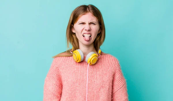 Red Head Pretty Woman Feeling Disgusted Irritated Tongue Out Headphones — Stockfoto