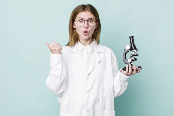 Red Head Pretty Woman Looking Astonished Disbelief Scientist Microscope Concept — Stockfoto