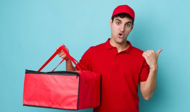 Yakışıklı İspanyol adam inançsızlığa şaşırmış görünüyor. Pizza dağıtımı kavramı