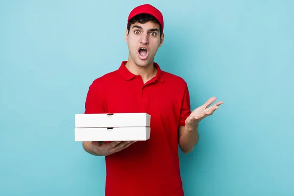 Handsome Hispanic Man Feeling Extremely Shocked Surprised Delivery Pizza Concept — Stock Photo, Image