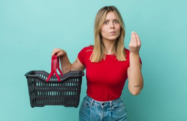 Güzel sarışın kadın kapiş ya da para hareketi yapıyor, sana ödemeni söylüyor. Alışveriş sepeti konsepti