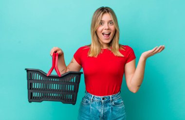 Güzel sarışın kadın kendini mutlu hissediyor, bir çözüm ya da fikir bulduğuna şaşırıyor. Alışveriş sepeti konsepti