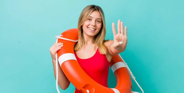 Pretty Blonde Woman Smiling Looking Friendly Showing Number Four Lifeguard — Stock Photo, Image