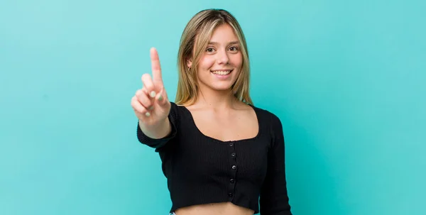 Young Pretty Blonde Woman Smiling Looking Friendly Showing Number One — Stock Photo, Image