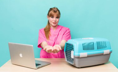 Kızıl saçlı, güzel bir kadın arkadaşça gülümsüyor ve bir konsept sunuyor. Veterinerlik kavramı