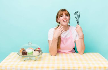 Kızıl saçlı güzel kadın umutsuz, hayal kırıklığına uğramış ve stresli görünüyor. Ev yapımı kek konsepti