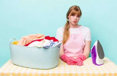 Kızıl saçlı, güzel bir kadın üzgün ve mızmızlanıyor. Mutsuz bir bakışı var ve ağlıyor. Demir giysi konsepti