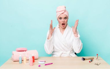 Kızıl saçlı güzel kadın ellerini havaya kaldırarak çığlık atıyor. duş ve kozmetik konsepti