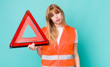 Kızıl saçlı, güzel bir kadın üzgün ve mızmızlanıyor. Mutsuz bir bakışı var ve ağlıyor. araba acil üçgeni