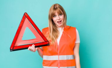 red head pretty woman looking happy and pleasantly surprised. car emergency triangle clipart