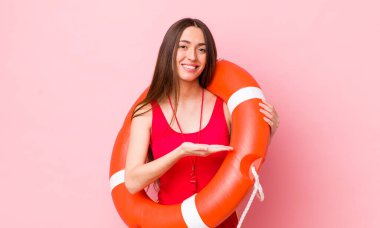 İspanyol güzel kadın neşeyle gülümsüyor, mutlu hissediyor ve bir konsept gösteriyor. cankurtaran konsepti