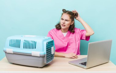 Genç ve güzel bir kadın mutlu bir şekilde gülümsüyor ve hayal kuruyor ya da şüphe ediyor. Veterinerlik kavramı