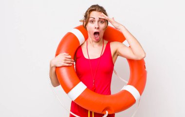 young pretty woman  looking happy, astonished and surprised. lifeguard concept