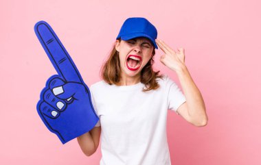 Genç ve güzel bir kadın mutsuz ve stresli görünüyor, intihar jesti silah işareti yapıyor. Bir numaralı hayran konsepti