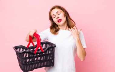 Genç ve güzel bir kadın stresli, endişeli, yorgun ve hayal kırıklığına uğramış hissediyor. boş alışveriş sepeti kavramı