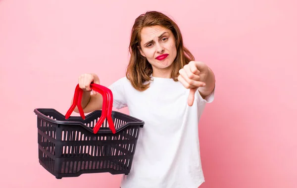Young Pretty Woman Feeling Cross Showing Thumbs Empty Shopping Basket — Foto Stock