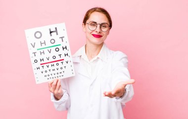 Genç ve güzel bir kadın arkadaşça gülümsüyor ve bir konsept sunuyor. Optik görüş testi konsepti. Mikroskop konseptine sahip bilim adamı