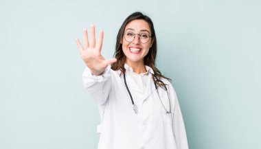 young pretty woman  smiling and looking friendly, showing number five. physician concept