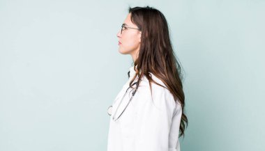 young pretty woman  on profile view thinking, imagining or daydreaming. physician concept