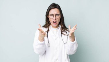 young pretty woman  feeling extremely shocked and surprised. physician concept
