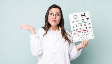 young pretty woman  feeling puzzled and confused and doubting. optical vision test concept