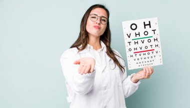 young pretty woman  smiling happily with friendly and  offering and showing a concept. optical vision test concept