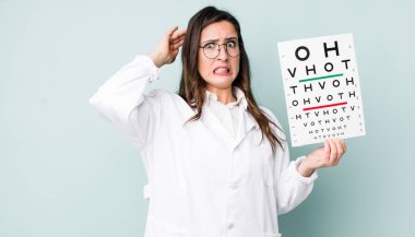 young pretty woman  feeling stressed, anxious or scared, with hands on head. optical vision test concept