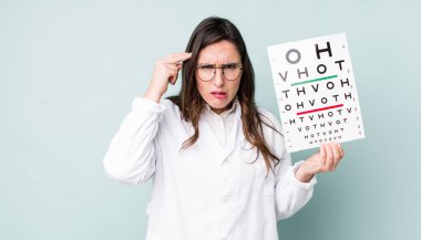 young pretty woman  feeling confused and puzzled, showing you are insane. optical vision test concept