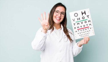 young pretty woman  smiling and looking friendly, showing number four. optical vision test concept