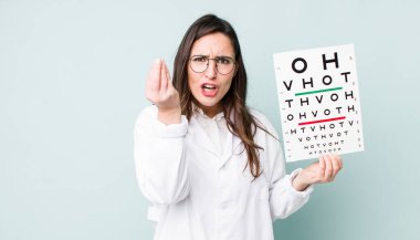 young pretty woman  making capice or money gesture, telling you to pay. optical vision test concept