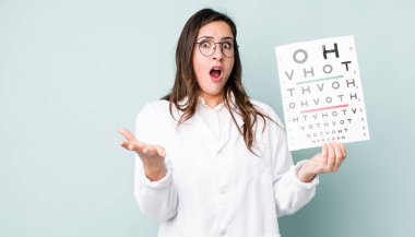 young pretty woman  amazed, shocked and astonished with an unbelievable surprise. optical vision test concept